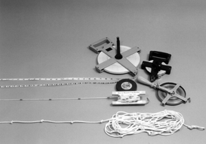 Figure 1. Measuring devices used for determining percent residue cover: tape measures; specially made cord with attached plastic beads; and knotted rope.