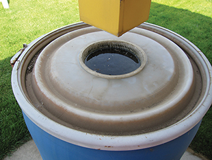 Figure 3. Barrel placed beneath the downspout. Excess water may overflow more readily out of this type of opening. 
