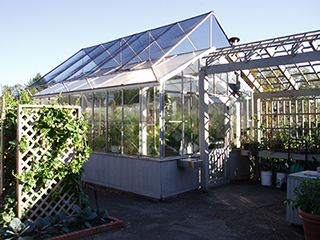 Figure 6. A hobby greenhouse with glass sidewalls and polycarbonate roof covering. 