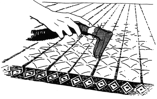 Figure 1.	Small particles of dust and dirt abrade fibers and damage the quilt. One cleaning method is to lay out the quilt and carefully vacuum it. Place a section of sheer polyester or cotton cheesecloth over the vacuum nozzle to prevent the quilt from being pulled into the nozzle. 
