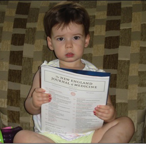 Figure 2. Toddlers enjoy being read to and will often model adult behaviors by pointing, making relevant noises, and turning pages. 