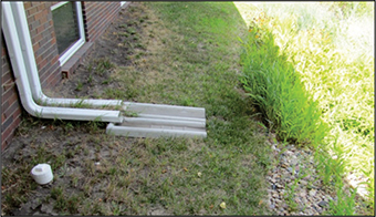 Figure 9. Downspout extensions and splash blocks directing roof runoff to a rain garden.